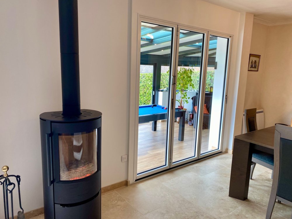 Nouveauté dans l'Ain (01) : Remplacement d’une baie coulissante par une baie accordéon sur-mesure pour une ouverture totale sur la véranda..