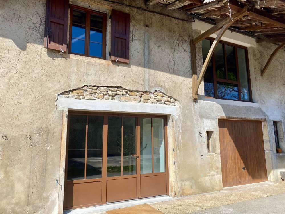 Installation d'un ensemble composé avec deux ouvrants en aluminium effet rouille dans une maison située dans l'Ain (01) 