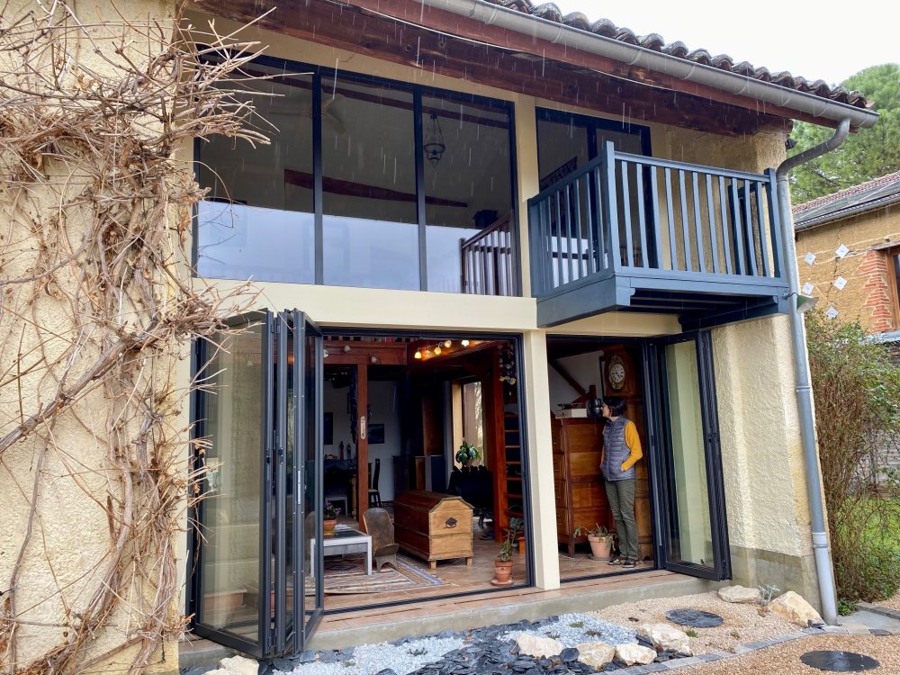 Pose de baies accordéon et d'un châssis fixe dans une charmante maison située dans l'Ain